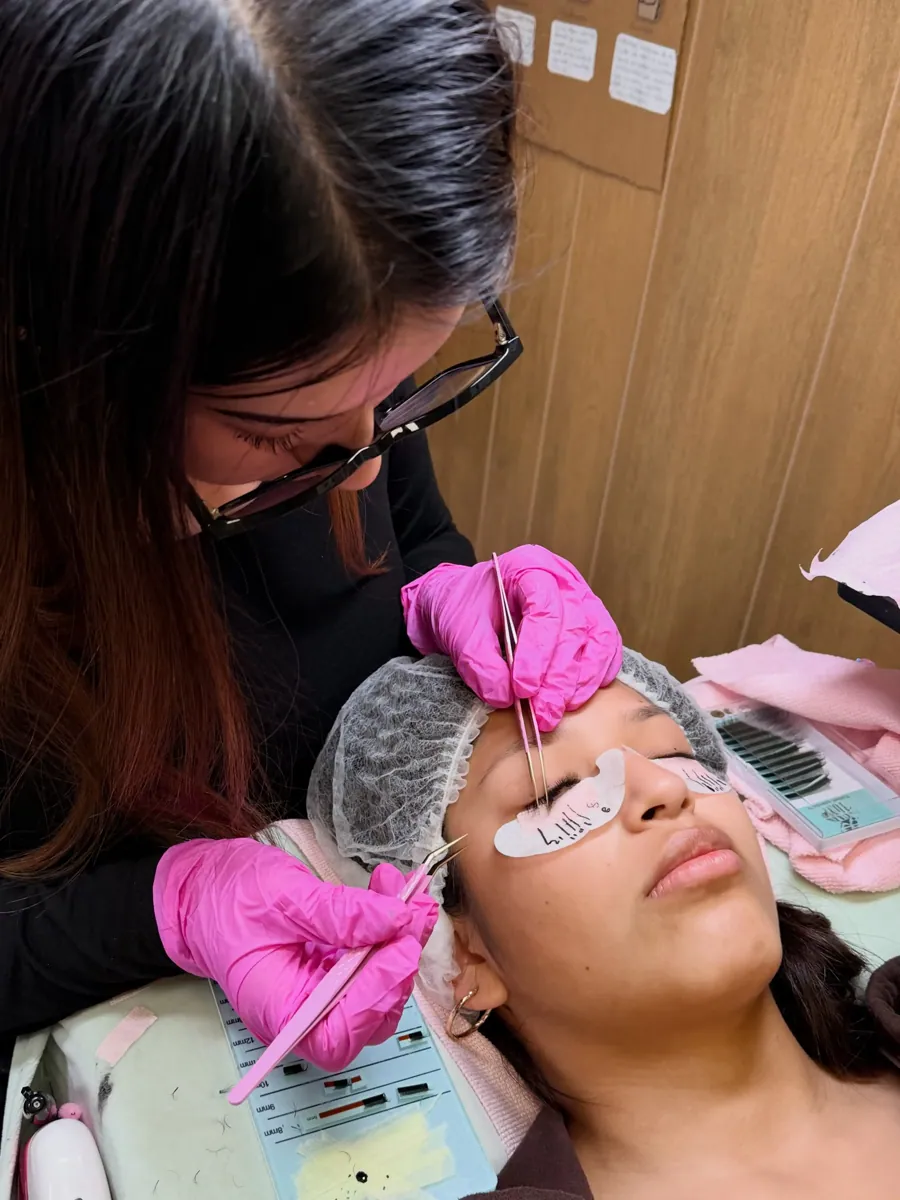Belle Academy student practicing lash extension techniques during hands-on training