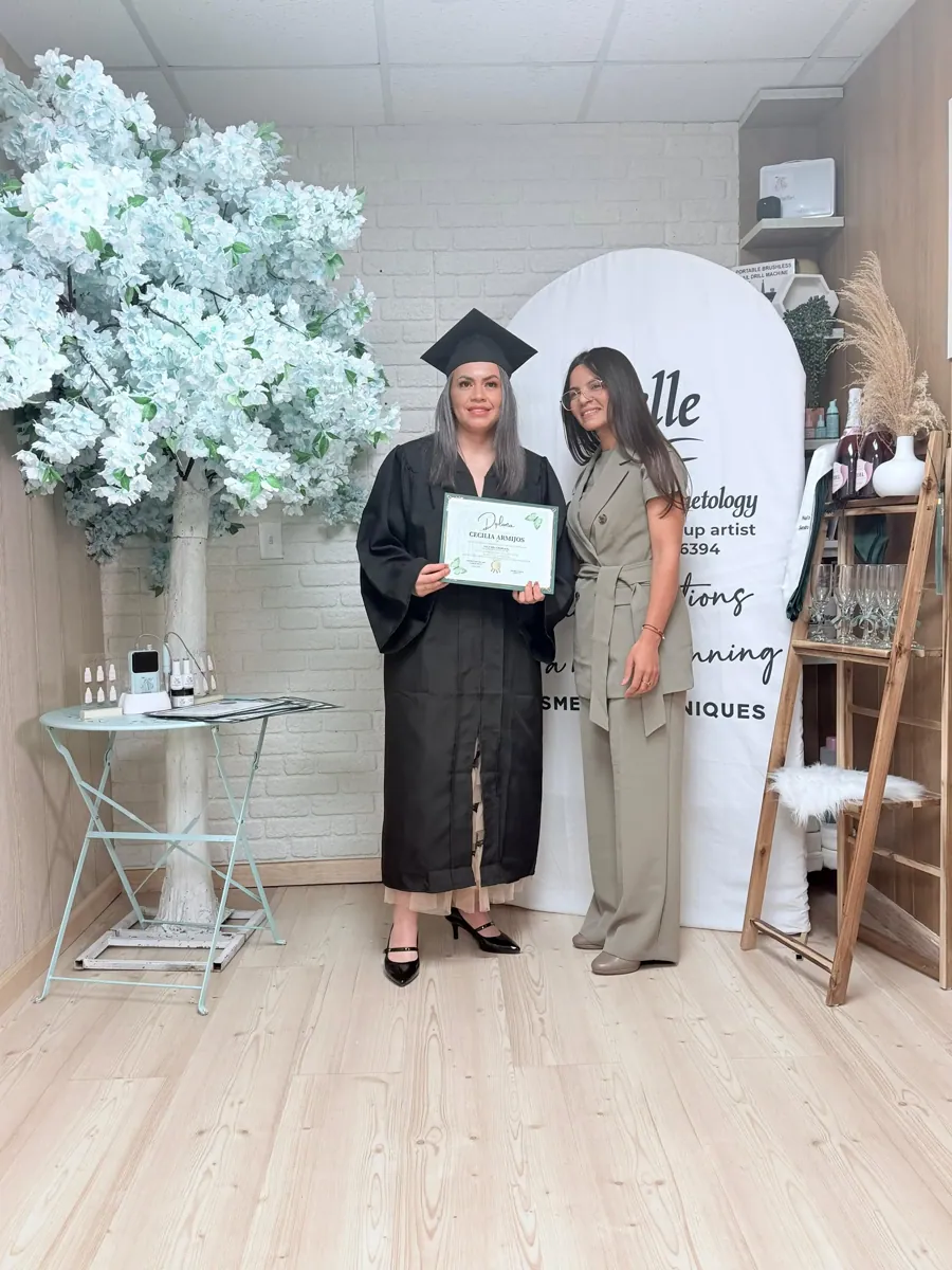 Belle Academy graduate with instructor in neutral salon setting