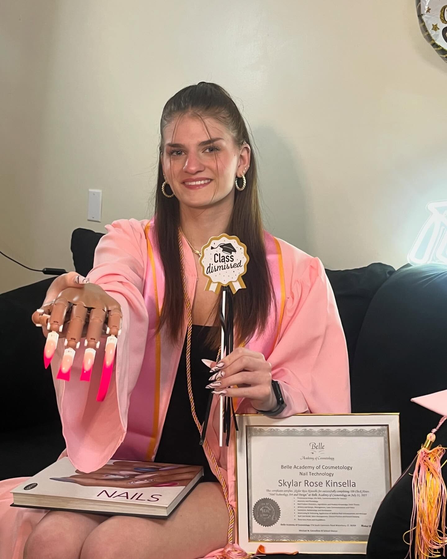 Belle Academy graduate holding certificate